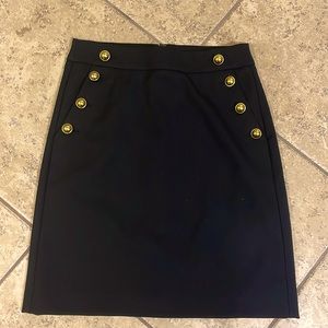 Mini black skirt with gold side buttons